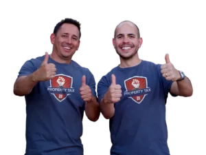Peter and Isaac, founders of NM Property Tax Protest, smiling and giving thumbs up in company shirts